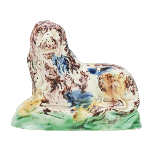 637 - A Whieldon type pottery figure of a lion. Circa 1780, modelled in a recumbent pose and splashed in b... 