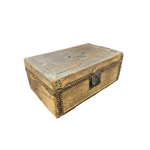 713 - A hide and studded leather covered document box. 18th century, with an applied brass label inscribed... 