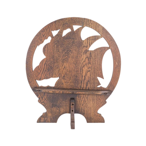 717 - An arts and crafts carved oak fire screen. Of circular form, carved with a galleon on high seas, hei... 