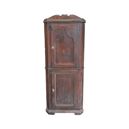 738 - A 19th century painted pine floor standing corner cupboard. With a shaped cornice above an arched pa... 