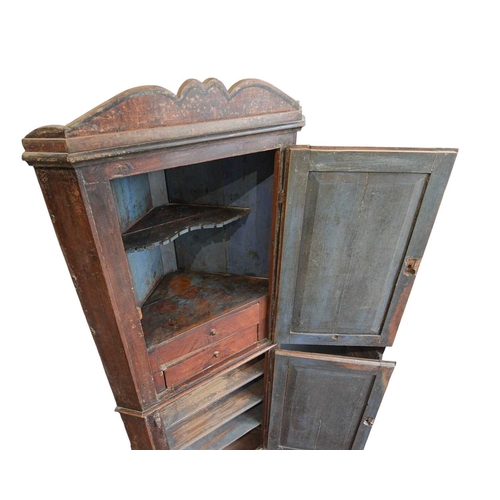 738 - A 19th century painted pine floor standing corner cupboard. With a shaped cornice above an arched pa... 