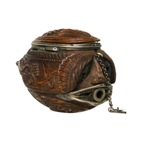 741 - A charming coquilla nut bugbear snuff box. Late 18th century, the base carved an eagle, with vine an... 