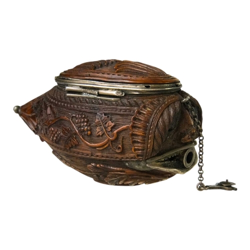 741 - A charming coquilla nut bugbear snuff box. Late 18th century, the base carved an eagle, with vine an... 