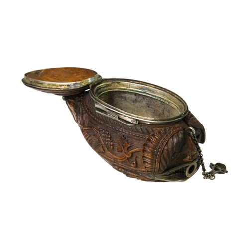 741 - A charming coquilla nut bugbear snuff box. Late 18th century, the base carved an eagle, with vine an... 
