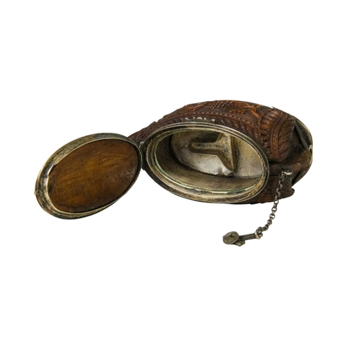 741 - A charming coquilla nut bugbear snuff box. Late 18th century, the base carved an eagle, with vine an... 