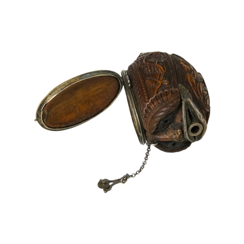 741 - A charming coquilla nut bugbear snuff box. Late 18th century, the base carved an eagle, with vine an... 