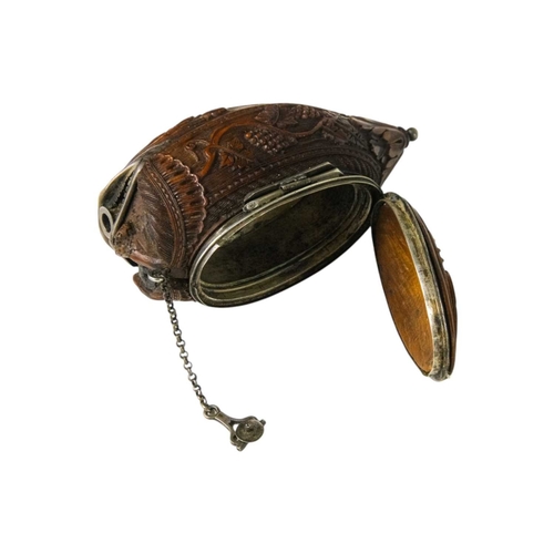 741 - A charming coquilla nut bugbear snuff box. Late 18th century, the base carved an eagle, with vine an... 