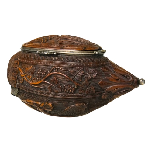 741 - A charming coquilla nut bugbear snuff box. Late 18th century, the base carved an eagle, with vine an... 