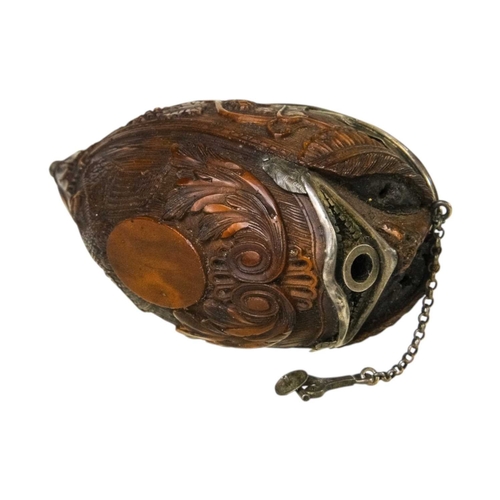 741 - A charming coquilla nut bugbear snuff box. Late 18th century, the base carved an eagle, with vine an... 