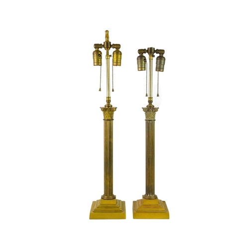 746 - A pair of heavy brass table lamps of Corinthian column form. With adjustable fittings for two bulbs.... 