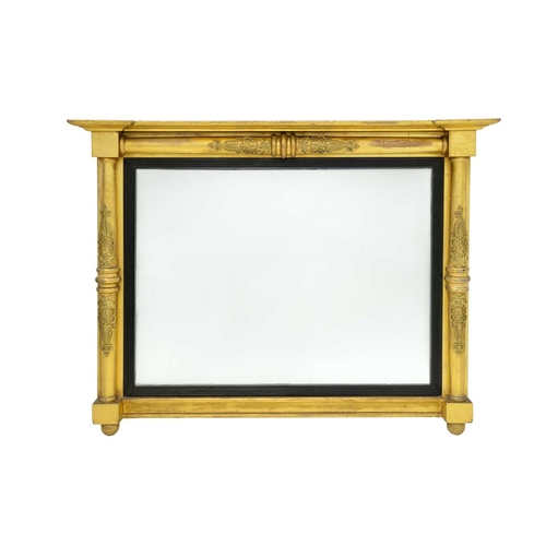 760 - A Regency gilt overmantel mirror. The rectangular plate with an ebonised slip within plain column fl... 