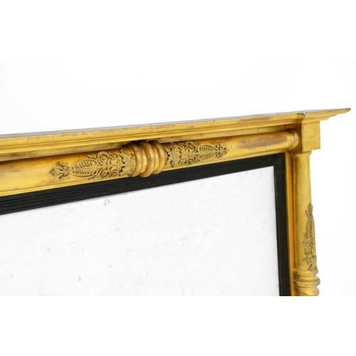 760 - A Regency gilt overmantel mirror. The rectangular plate with an ebonised slip within plain column fl... 