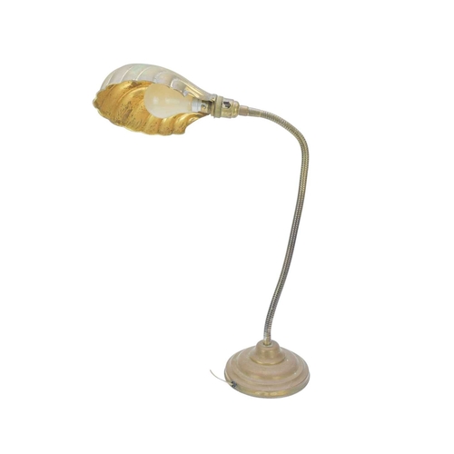761 - A mid 20th century adjustable brass desk lamp. With an embossed clamshell shade, on a weighted circu... 
