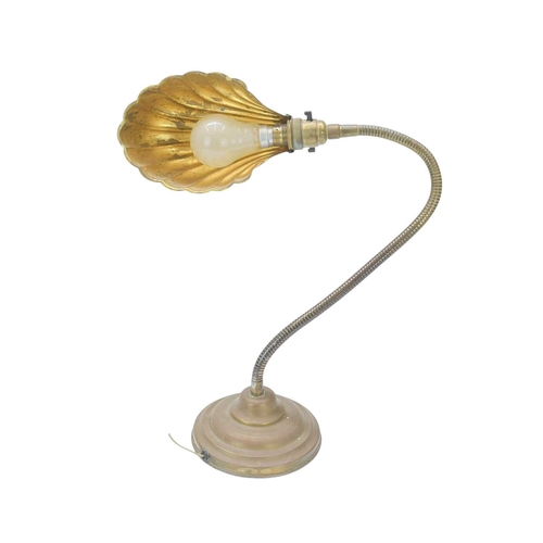 761 - A mid 20th century adjustable brass desk lamp. With an embossed clamshell shade, on a weighted circu... 