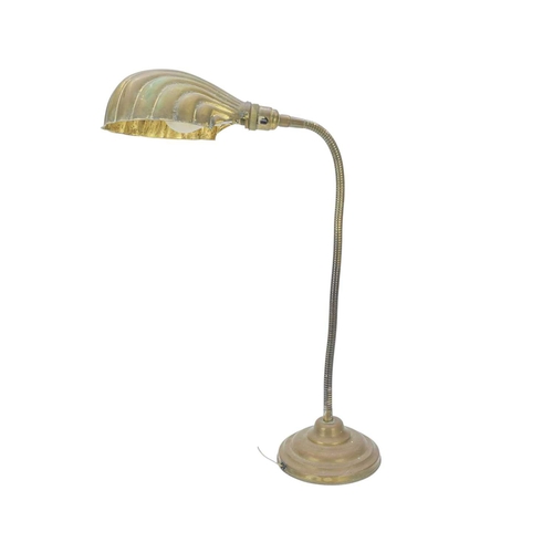 761 - A mid 20th century adjustable brass desk lamp. With an embossed clamshell shade, on a weighted circu... 