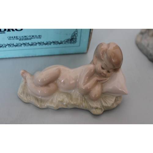 26 - Two Lladro Figurines. Smallest is Sleeping Boy in Original Box. Other is lady figurine measuring 30c... 
