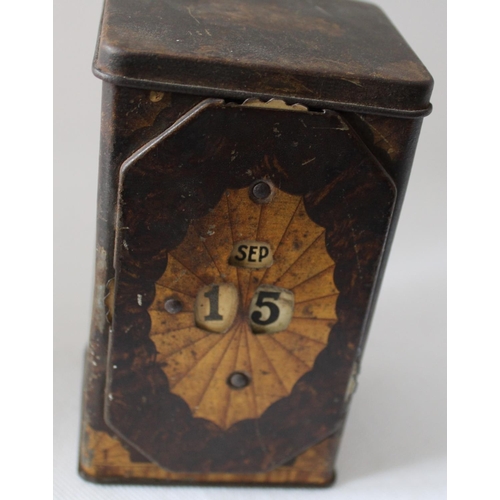 44 - Vintage Tea Caddy with Calendar Wheel on Front. Stands 13cm tall by 7.5cm wide approx