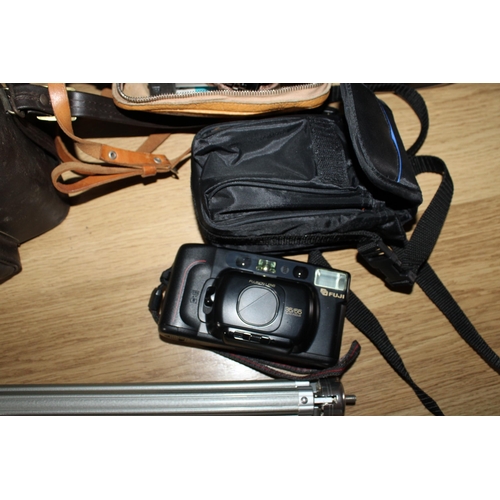 107 - Three Cameras Plus Accessories and Tripod
Untested
