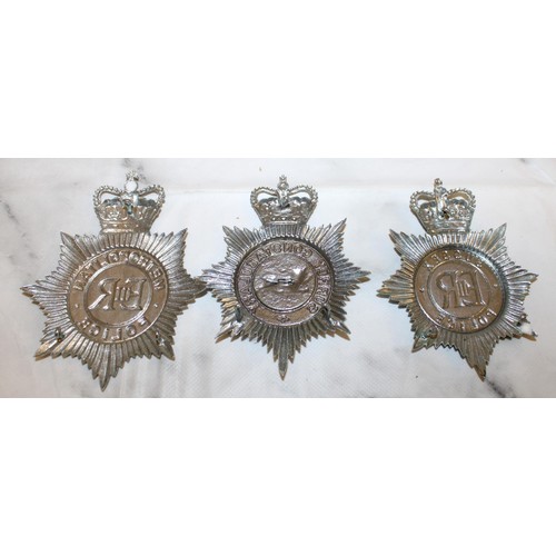 57 - Three ERII Police Helmet Plate Badges  

Metropolitan Police 
Sussex Police
Surrey Constabulary