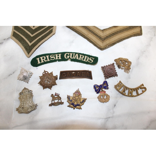 511 - Collection of Military Uniform insignia and Badges