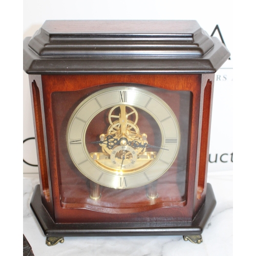 324 - Three Clocks Including Two Mantel and One Swiss Style Clock
One Mantel Clock with Pendulum and Key
S... 