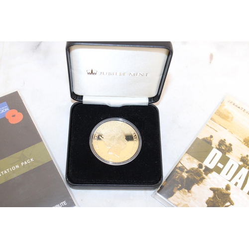 335 - Three Collectable Coins Inc-Jubilee Mint Boxed Lest We Forget 2018 One Crown
D-DAY £5 Coin Presentat... 