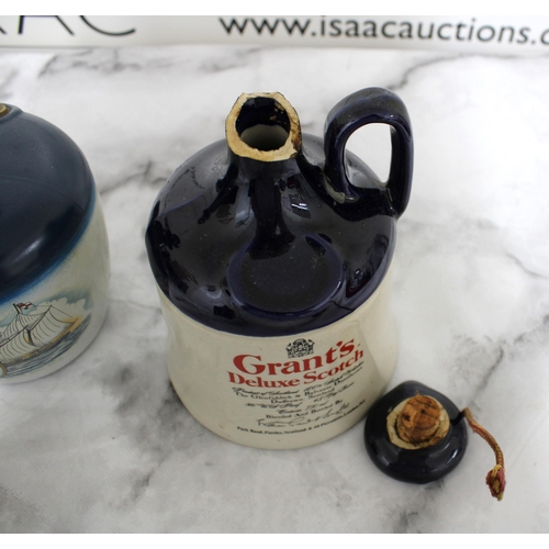 197 - Three Collectable Decanters Inc-
Grant's Deluxe Scotch (Damage To Top Shown In Pictures)
Alfred Lamb... 