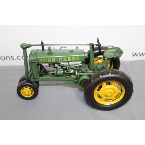 684 - Boxed Tin Plate John Deere Tractor
Length 26cm