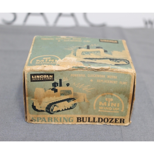 706 - Boxed Vintage Lincoln International Mini Windup Sparking Bulldozer