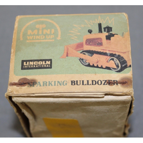 706 - Boxed Vintage Lincoln International Mini Windup Sparking Bulldozer