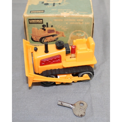 706 - Boxed Vintage Lincoln International Mini Windup Sparking Bulldozer