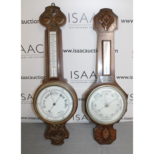 65 - Two Wooden Barometers 
Height 82cm
COLLECTION ONLY