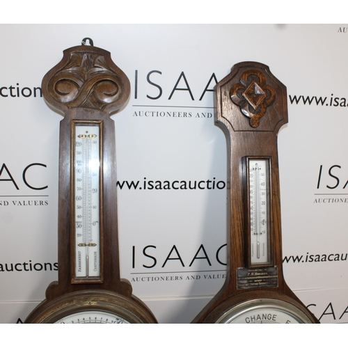 65 - Two Wooden Barometers 
Height 82cm
COLLECTION ONLY