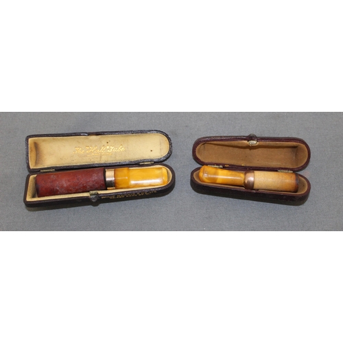 99 - Two Cased Yellow Metal Cheroots