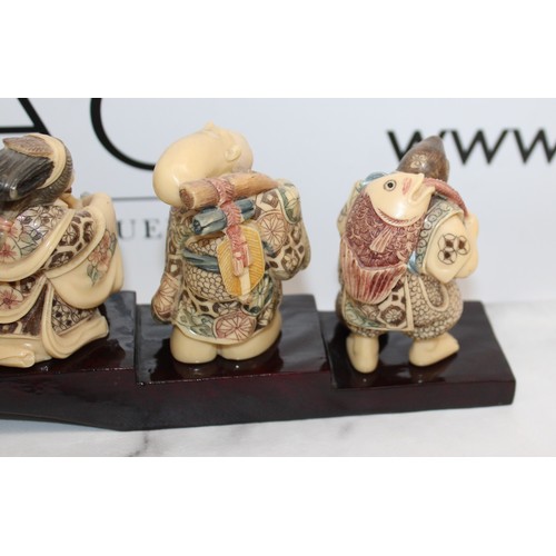 231 - 7 Decorative Japanese Immortals On A Plinth Length-46cm Height Of Figures Tallest 8cm