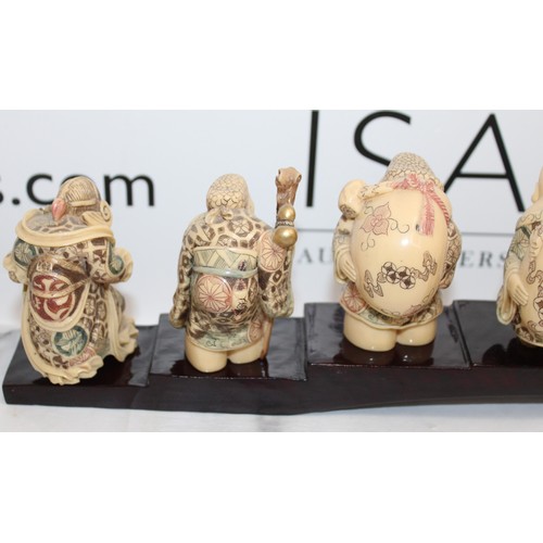 231 - 7 Decorative Japanese Immortals On A Plinth Length-46cm Height Of Figures Tallest 8cm