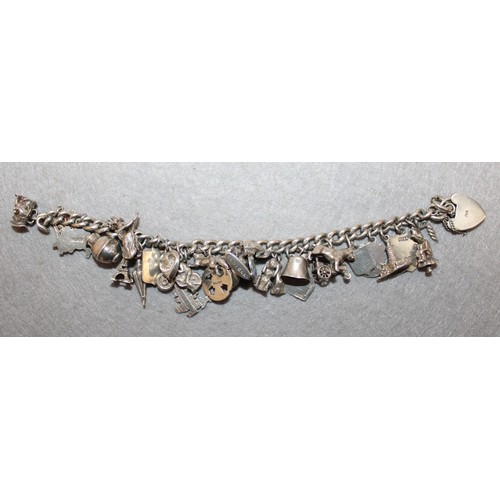 595 - Stamped SILVER Charm Bracelet With Quantity Of Silver Charms