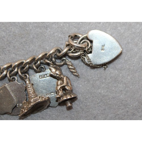 595 - Stamped SILVER Charm Bracelet With Quantity Of Silver Charms