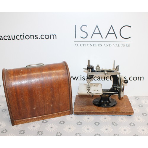 193 - Wooden Cased Lead Miniature Toy Sewing Machine A Japanese 