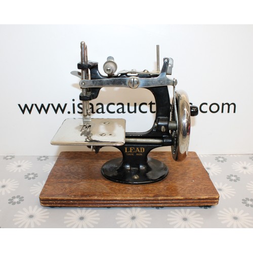 193 - Wooden Cased Lead Miniature Toy Sewing Machine A Japanese 