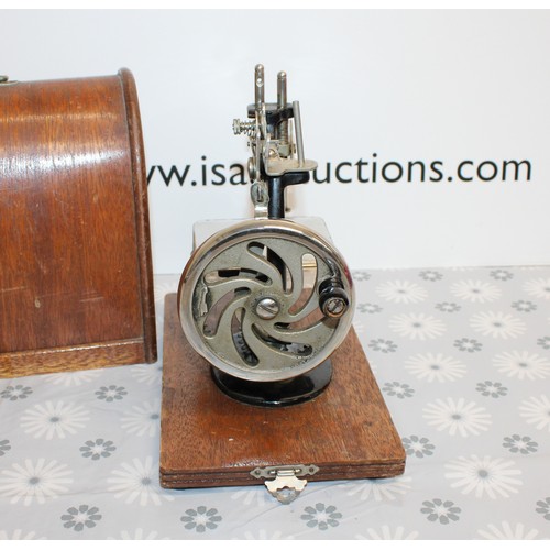 193 - Wooden Cased Lead Miniature Toy Sewing Machine A Japanese 