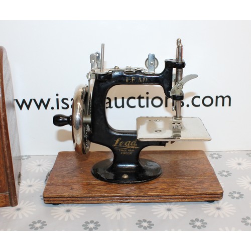 193 - Wooden Cased Lead Miniature Toy Sewing Machine A Japanese 