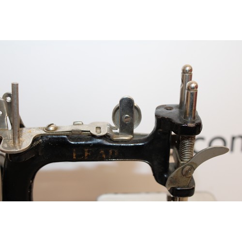 193 - Wooden Cased Lead Miniature Toy Sewing Machine A Japanese 