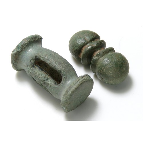 5 - Late Iron age to Roman bronze toggles, one a balauster type with slots for attachment, the other a d... 