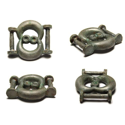 Iron Age Celtic Strap Junction. Circa, 50 AD. Copper-alloy, 25.43 grams. 45.11 mm. A double crescent motif enclosing two circular eye type mouldings with a wide strap-bar at each end. Ref: Mills, Celtic & Roman Artefacts. p.28.