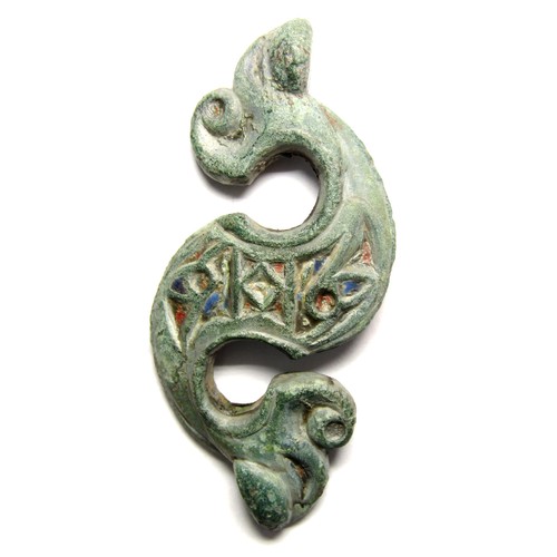 Romano-British Dragonesque Brooch. Circa, 50 AD. Copper-alloy, 11.35 grams. 47.28 mm. A very good example of the Celtic inspired zoomorphic brooches. Formed of an S-shaped body with a stylised animal head at each end and decorated with enamelled panels across the body. Ref: Catherine Johns, The Jewellery of Roman Britain. Celtic and Classical Traditions. p.152. fig. 7.2.