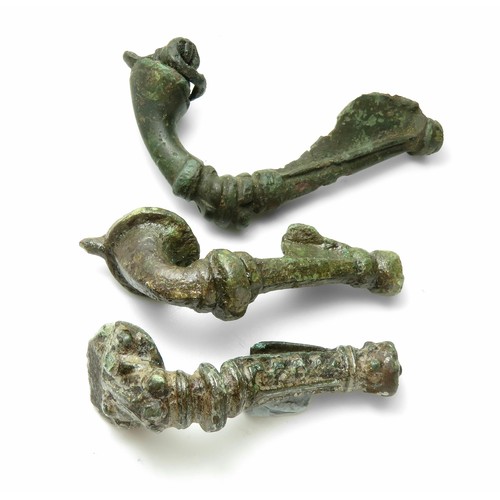 24 - Three Roman bronze trumpet brooches, 1st - 2nd century AD. Largest 60mm.