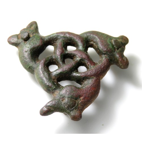 48 - Viking Urnes style openwork mount. Circa, 11th century AD. Copper-alloy, 31 mm x 9 mm. Formed of thr... 