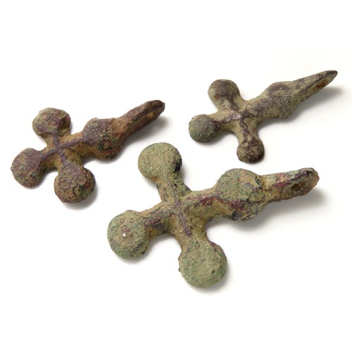 62 - Medieval cross pendant group. Three medieval bronze cruciform harness pendants, each in the form of ... 