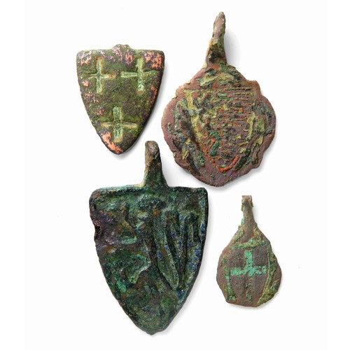 68 - Medieval heraldic pendant group. A group of four medieval heraldic harness pendants,  bronze with so... 